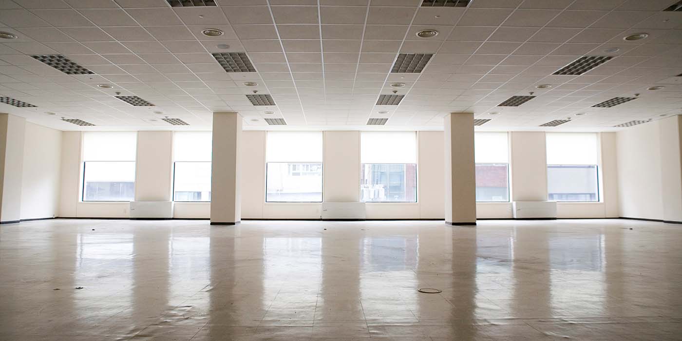 Empty office space with large windows.